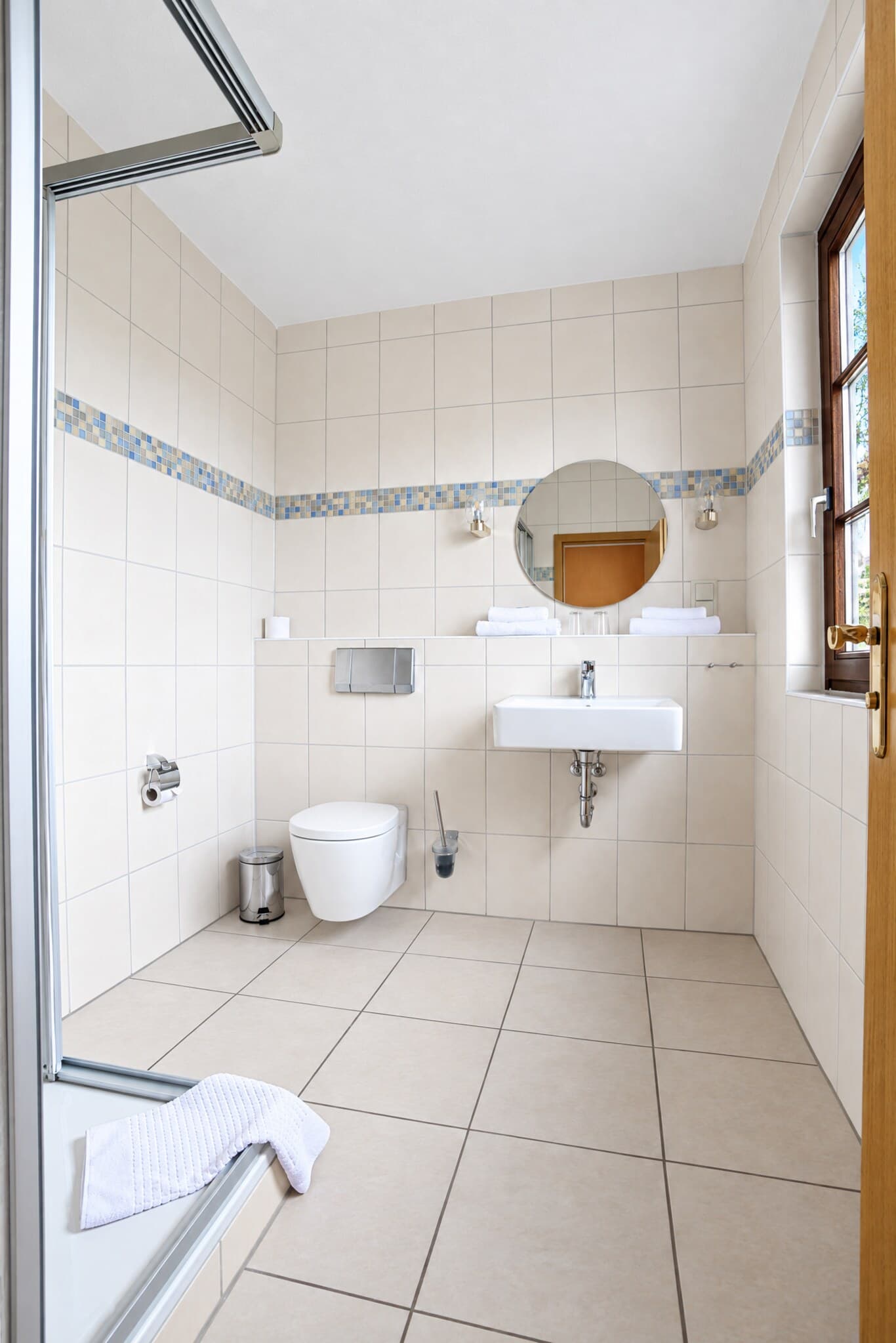 Helles Bad der Junior-Suite mit Dusche, Waschbecken und Fenster